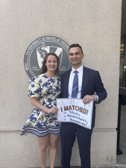 Michal and Austin holding a match day sign