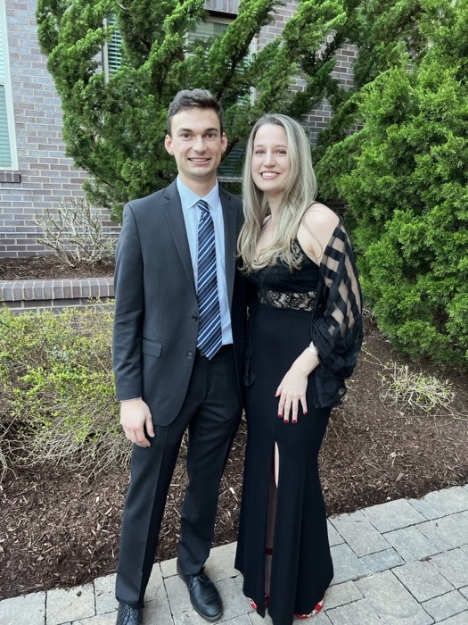 Michal and Austin dressed up in a garden